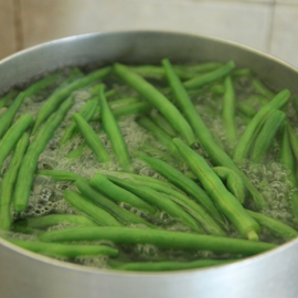 green beans are cooked in a saucepan