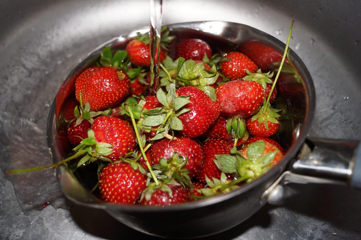 strawberries under running water